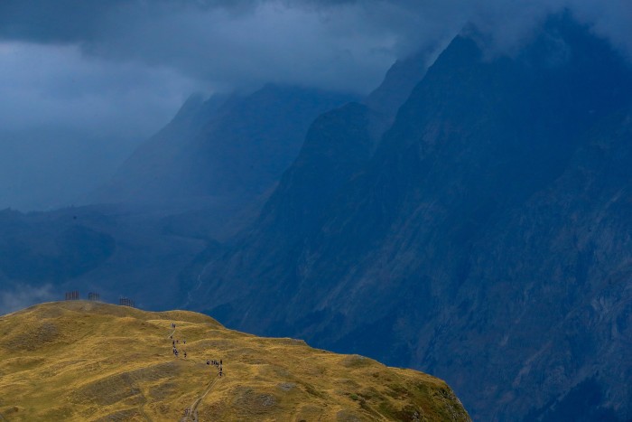 Clouds loom on the morning of August 26 as competitors skirt the southern slopes of the Mont Blanc massif